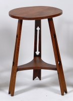 Lot 411 - An Art Nouveau oak two tier occasional table,...