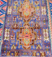 Lot 939 - A Persian woollen rug, having a blue ground...