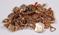 Lot 640 - A gold charm bracelet, principally 9ct...