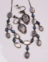 Lot 645 - A 1920s white metal moonstone and cabochon...