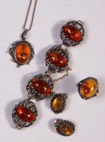 Lot 659 - A contemporary white metal and amber set four...