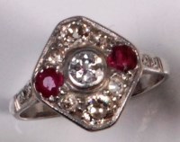 Lot 699 - A platinum, ruby and diamond set panel ring,...