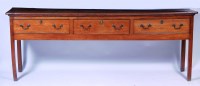 Lot 1016 - A George III elm dresser base, having three...