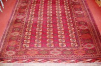 Lot 948 - A Persian woollen red ground Bokhara carpet,...