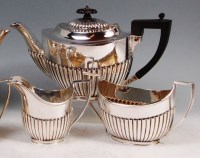 Lot 583 - A George V silver three piece teaset,...