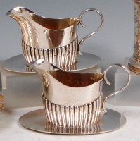 Lot 596 - A pair of Edwardian silver cream jugs, each on...