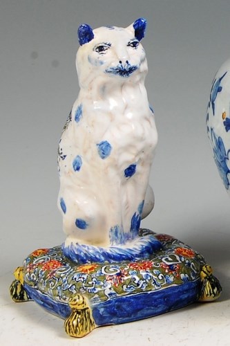 Lot 581 - An 18th century Delft figure of a cat, in...