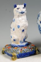 Lot 581 - An 18th century Delft figure of a cat, in...