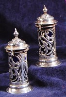 Lot 615 - A pair of Edwardian silver pepperettes, each...