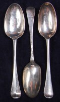 Lot 648 - Three George II silver dessert spoons, two in...