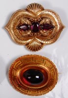 Lot 714 - A circa 1900 yellow gold and cabochon ruby set...