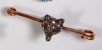 Lot 734 - A yellow gold foxes head safety pin brooch,...