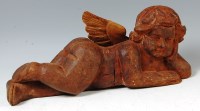 Lot 757 - A 17th/18th century carved oak cherub, in...