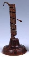 Lot 802 - A circa 1700 fruitwood and steel candle holder,...