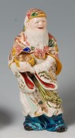 Lot 871 - A Chinese porcelain figure of an Immortal, in...