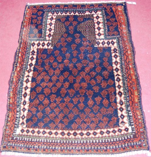 Lot 543 - A Persian woollen prayer rug, the blue ground...