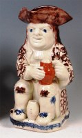 Lot 101 - A Prattware Toby jug, the seated tippler...