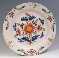 Lot 102 - A mid 18th century English Delft charger,...