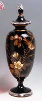 Lot 113 - A late Victorian black glass pedestal vase and...