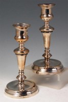 Lot 140 - A pair of George V silver table candlesticks,...