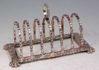 Lot 156 - A Regency style cast silver toast-rack, having...