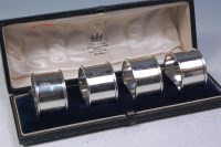 Lot 157 - A cased set of four George V silver napkin...