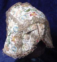 Lot 285 - A mid 17th century ladies embroidered nightcap,...