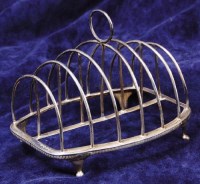 Lot 159 - A late Georgian silver six division toast-rack,...