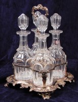 Lot 172 - A Victorian silver plated four bottle tantalus,...