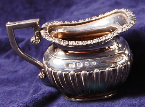 Lot 173 - A late Victorian silver cream jug, of half...