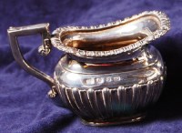 Lot 173 - A late Victorian silver cream jug, of half...