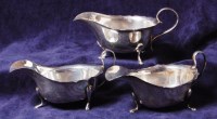 Lot 180 - A pair of George V silver sauceboats, each...