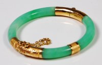 Lot 207 - A Chinese jade bangle, with embossed 18ct gold...