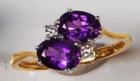 Lot 262 - An 18ct gold amethyst and diamond crossover...