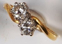 Lot 263 - An 18ct gold diamond crossover ring, the two...