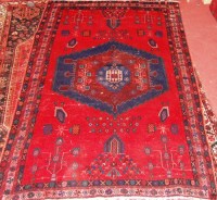 Lot 506 - A Kurdish woollen red ground rug, the whole...