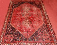 Lot 509 - A Persian Shiraz woollen carpet, the red...