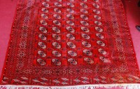 Lot 517 - A Persian woollen Bokhara carpet, the red...