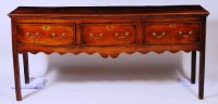 Lot 540 - A George III elm dresser base, having three...