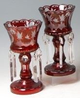 Lot 114 - A pair of Bohemian ruby glass pedestal lustres,...