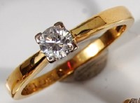 Lot 210 - An 18ct gold diamond solitaire ring, the claw...
