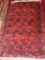 Lot 489 - A Persian Herat red ground woollen rug, having...