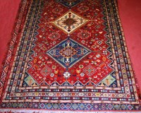 Lot 495 - A Persian Shiraz woollen carpet, the red...