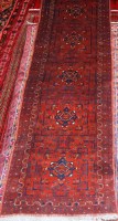 Lot 499 - A Persian woollen brown ground hall runner,...