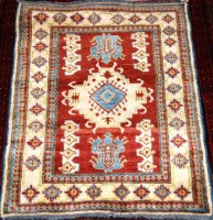 Lot 504 - A Persian Kazak woollen rug, having a red...