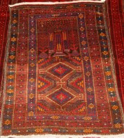 Lot 505 - A Persian woollen prayer rug, having an...