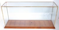 Lot 109 - A metal framed glass display cabinet on wood...