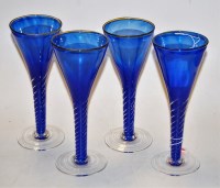 Lot 59 - A set of four contemporary blue glass wine...
