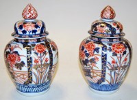 Lot 243 - A pair of Japanese Imari vases and covers,...