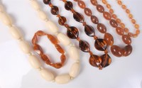 Lot 401 - Three faux amber bead necklaces, a bracelet,...